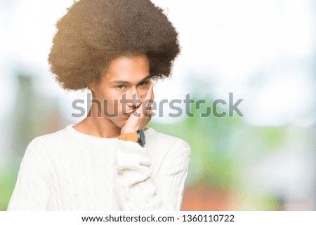 Young african american man with afro hair wearing winter sweater thinking looking tired and bored with depression problems with crossed arms.