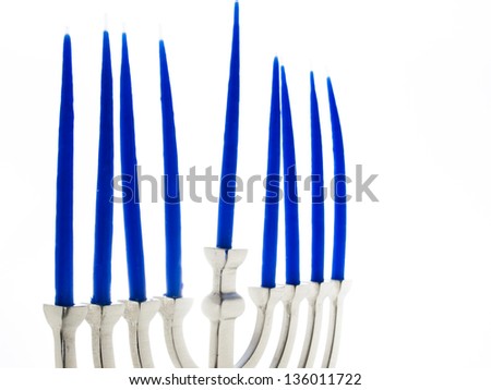 Contemporary menorah with blue candels on white background.