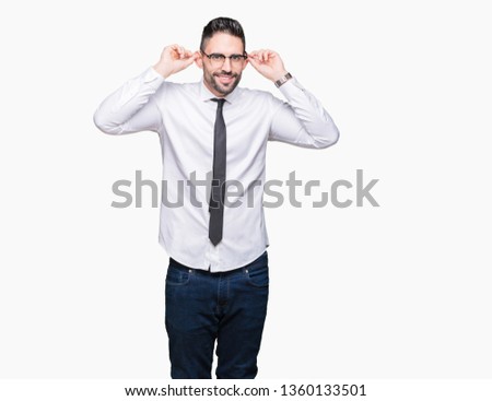Young handsome business man wearing glasses over isolated background Smiling pulling ears with fingers, funny gesture. Audition problem
