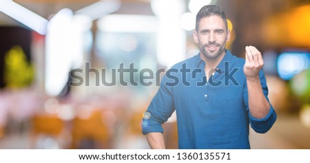 Young handsome man over isolated background Doing Italian gesture with hand and fingers confident expression