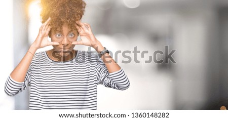 Beautiful young african american woman wearing glasses over isolated background Trying to open eyes with fingers, sleepy and tired for morning fatigue