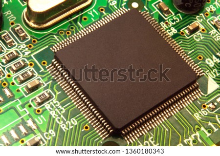 Close up on electronic board in hardware repair shop, blurred and toned image.