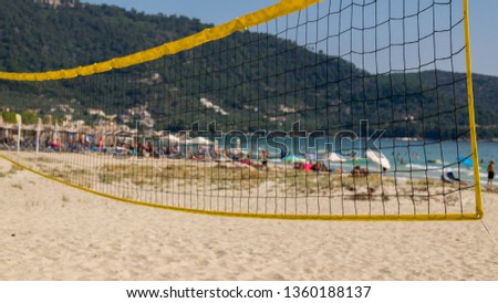beach volleyball, sand and protective umbrellas