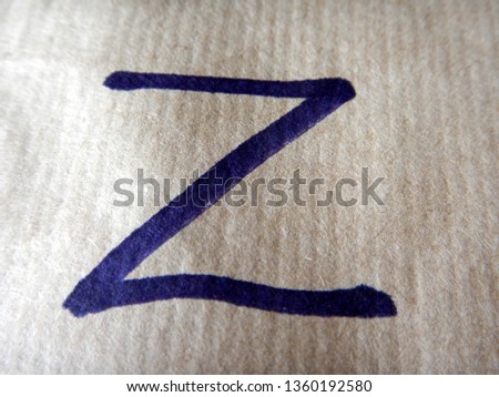 the alphabetical capital block letter Z writed on wrapping paper using a black felt tip pen Royalty-Free Stock Photo #1360192580