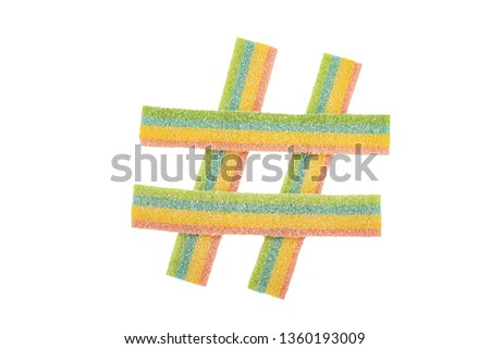 Colorful candy hashtag symbol isolated on white background. Top view.