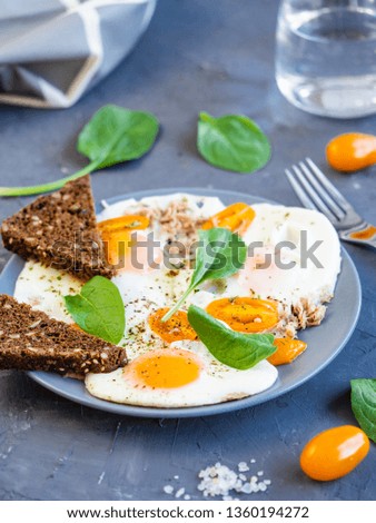 scrambled eggs with toast and greens