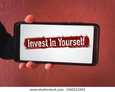 Text on a smart phone showing Invest In Yourself. Conceptual photo Improve your self