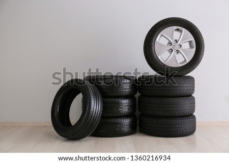 Car tires near light wall