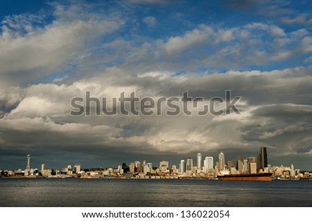 Seattle Skyline. Seattle is a major coastal seaport and is the largest city north of San Francisco. The cloudscapes in this Pacific Northwest city can be quite dramatic as the weather can be erratic. Royalty-Free Stock Photo #136022054
