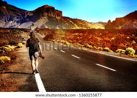 Nature travel and adventure photography concept. Professional nature photographer on mountain road.