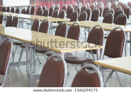 Perfectly set rows of new table and chairs in the conference hall