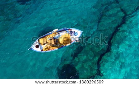 Aerial photo from traditional picturesque fishing boat on turquoise clear sea as seen from top in island of Paros, Cyclades, Greece