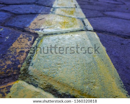 yellow line on a sidewalk