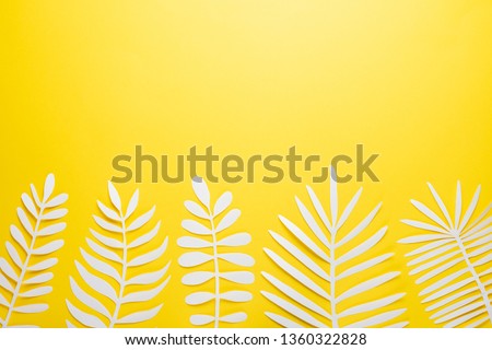 Tropical leaf pattern. Various paper leaves on a pastel background. art. Flat lay, top view. Background on yellow background. Lent background, summer mood