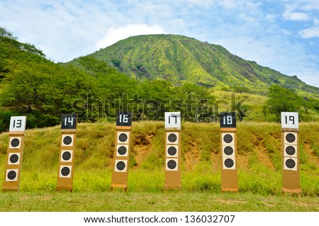 Targets for a shooting range with bulls-eye's are lined up in a row. Royalty-Free Stock Photo #136032707