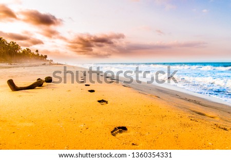 View on Foodsteps and sunset on the beach by Tayrona in Colombia