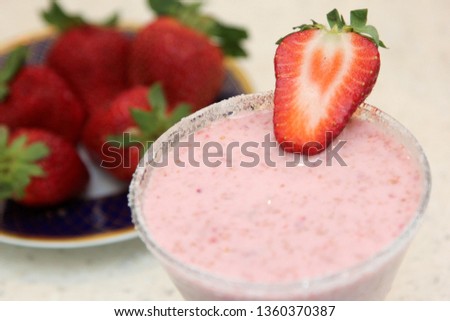 Glass of pink strawberry milkshake