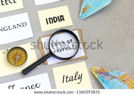 lets go travel text words, country selection, map magnifier compass, gray background