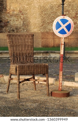 Old rattan chair and funny no parking sign 