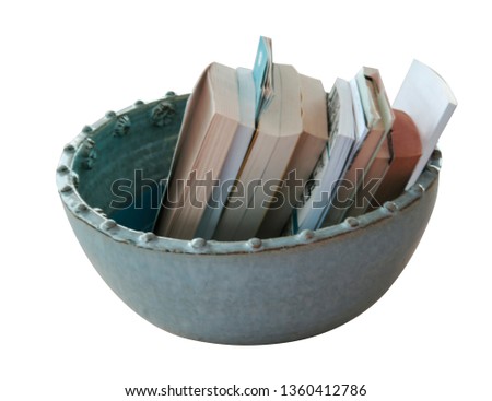 decorative ceramic vase with books isolated on white background