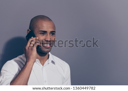 Close up side profile photo amazing dark skin he him his macho hold hand arm telephone smart phone speak tell say communicate relatives friends excited wear white shirt isolated grey background