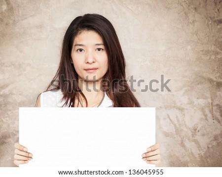 young asian woman holding blank sign