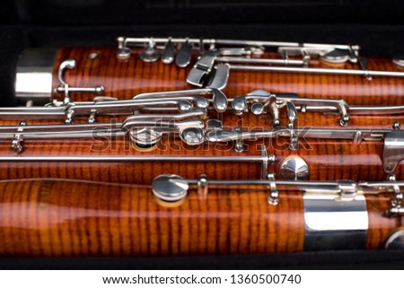 Wooden bassoon isolated on a black background. Music instruments. Royalty-Free Stock Photo #1360500740
