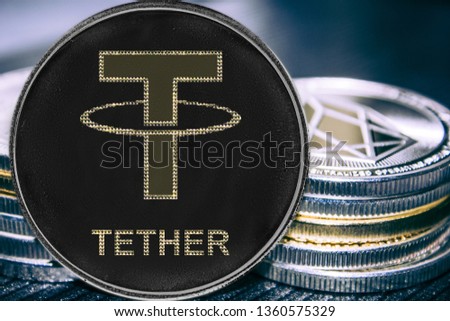 Coin cryptocurrency Tether on the background of a stack of coins. Token USDT.