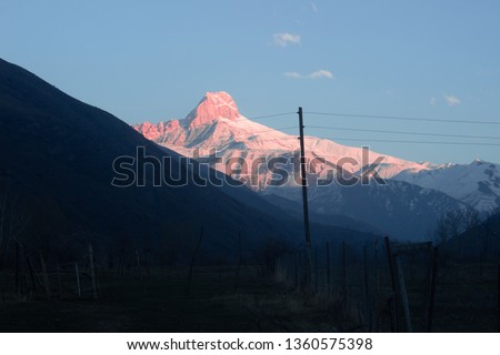 The sun falls on the mountain with snow. Mountain Of Shalbuz