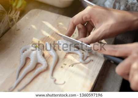 Close-up pictures using fresh squid pieces on a wooden cutting board