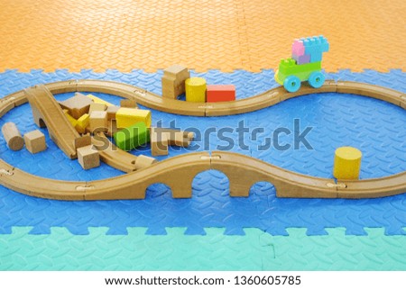 Wooden toy train set for children placed on the floor
