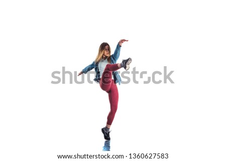 Cool female is showing aerobic moves in isolated room