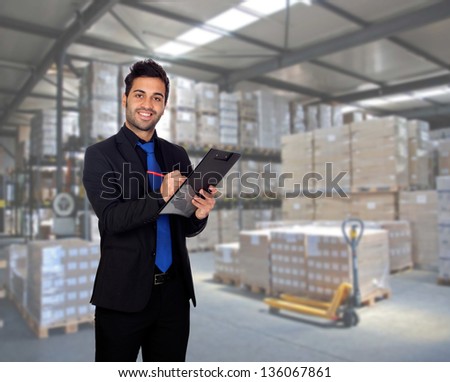 Young businessman with a clipboard in his workplace