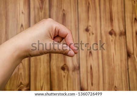 hand on wooden background close up