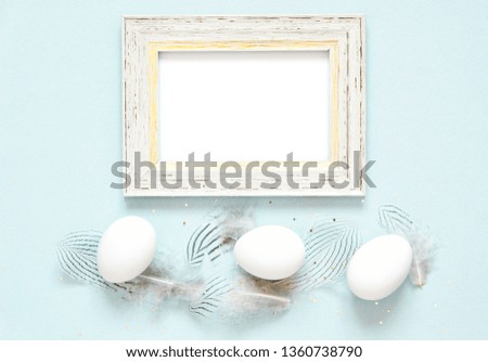 Frame with easter eggs and feathers. Happy Easter concept.