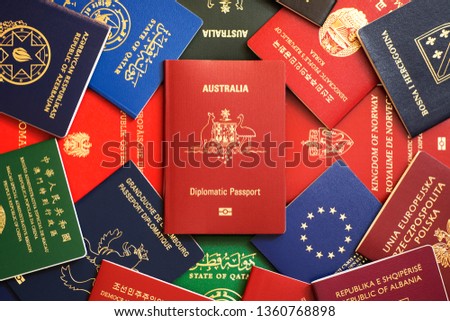 Australia's red biometric diplomatic passport among multicolored passports of many countries of the world