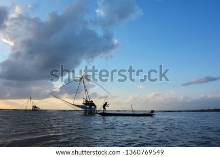 fisherman fishing on boat in the morning