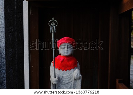 Stone statue with the red hat japan