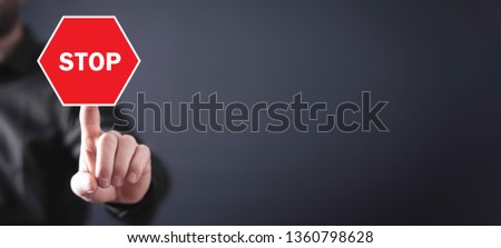Man hand with a red stop sign.