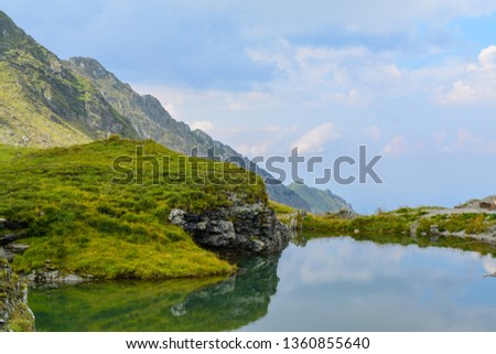 Mountain lake in clear sky beautiful skyline in Romania nature landscape background