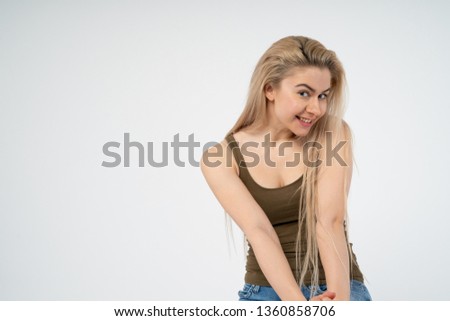 A young attractive girl is smiling and looking into the camera. Isolated on white background
