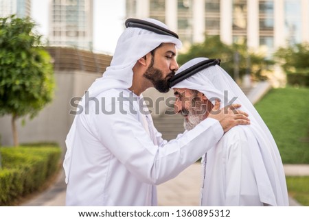 Group of arabian businessmen with kandura meeting outdoors in UAE - Middle-eastern men in Dubai Royalty-Free Stock Photo #1360895312