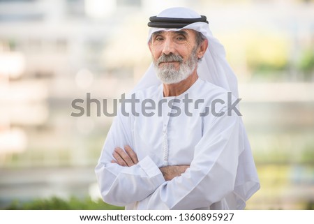 Arabian senior man with traditional white kandura portrait Royalty-Free Stock Photo #1360895927