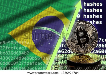 Brazil flag and rising green arrow on bitcoin mining screen and two physical golden bitcoins