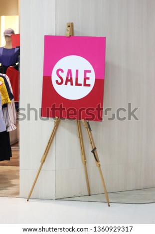 sign of sale on wood floor stand