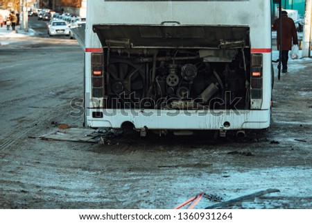 the passenger bus broke down the engine, open hood and exposed sign of an emergency stop on the road, public transport does not follow the route in anticipation of repair