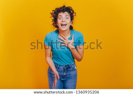 very emotional girl shows different gestures on an isolated yellow background. Concept of human emotions
