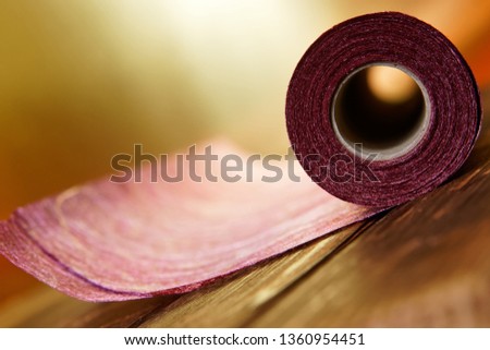 A roll of craft material from felt and paper for home needlework. Shallow depth of field