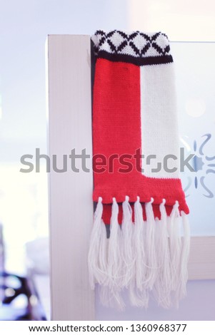 patterned scarves hanging on wooden poles