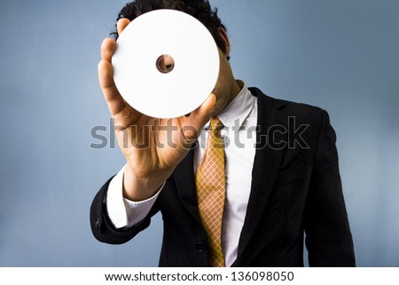 Man looking through blank DVD